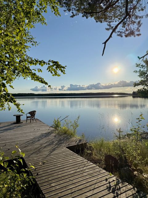 The dock in midsummer, a cable drum table and one wicker chair in the sun